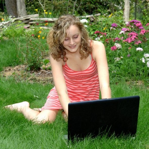 girl in garden on laptop